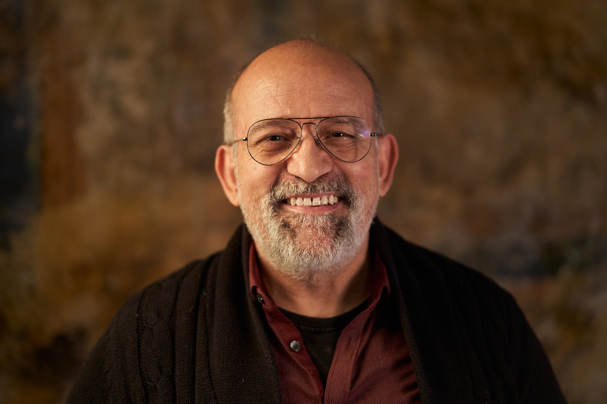 Portrait of a middle-aged Caucasian smiling man looking at camera. Look of an older person